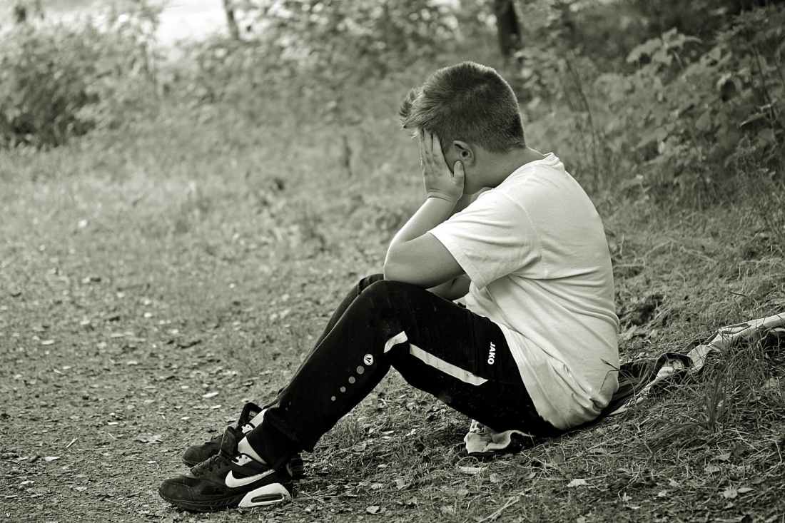 boy in white shirt and black track pants