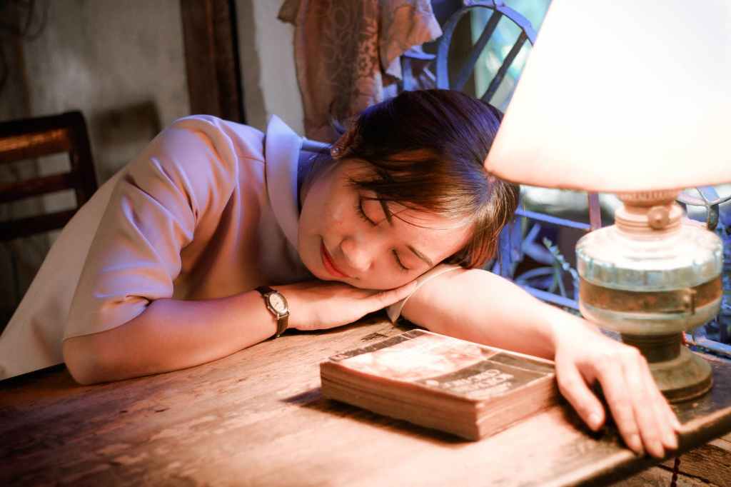 book girl indoors lampshade