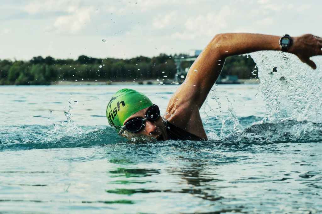 person swimming on body of water